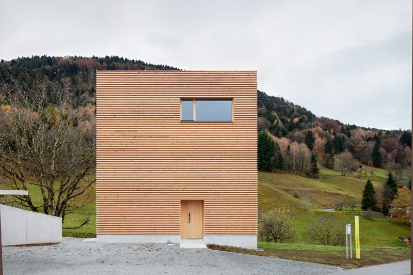 The minimalist timber-clad facade of an Alpine house