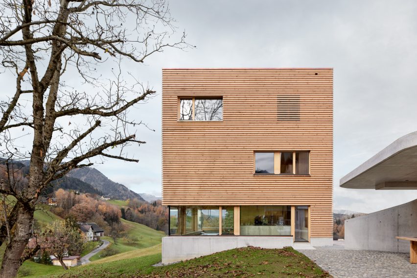 A square-shaped house clad in timber