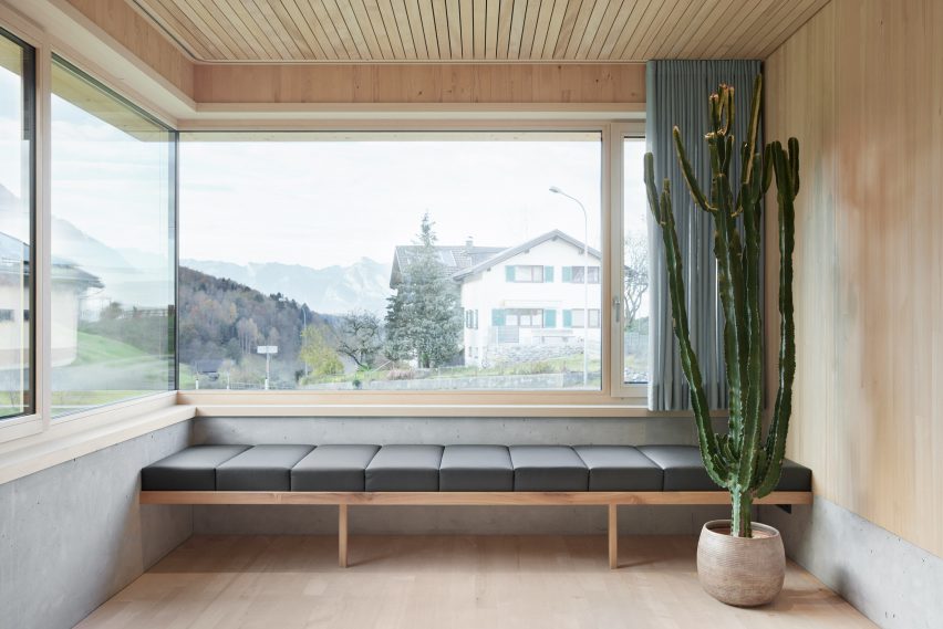 A spruce-lined room and dark sofa in an Austrian house