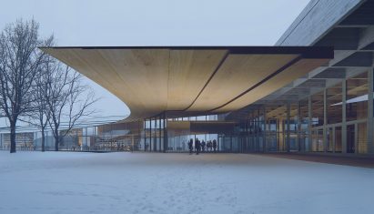 A building with a large overhanging wooden roof
