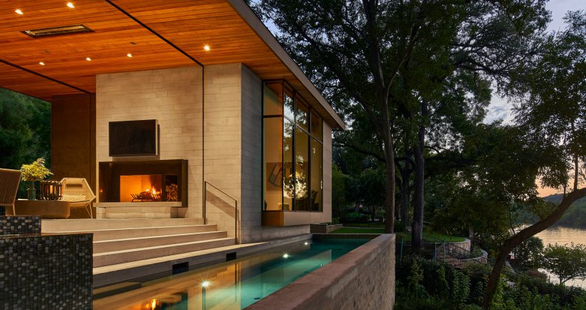 A narrow swimming pool overlooks the water