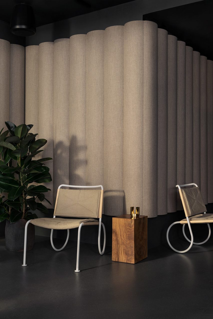 Easy chair by Peter Andersson with a white frame and beige upholstery in an interior
