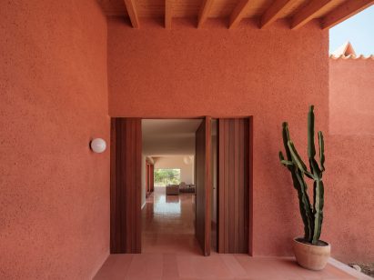 A sheltered entrance area with a pivoting door