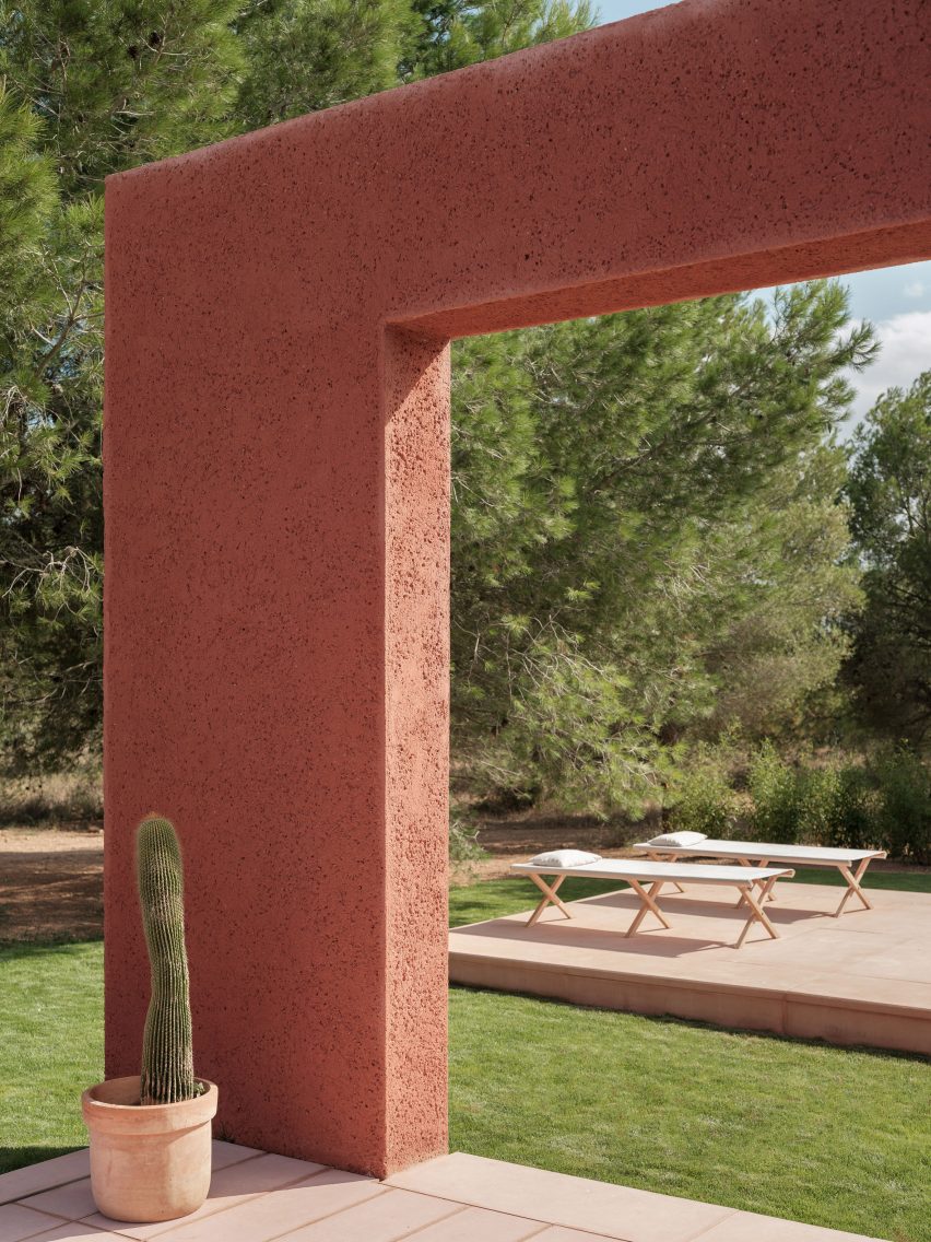 A terrace framed by a reddish mortar wall