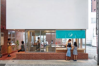 Customers outside brick-clad sweet store