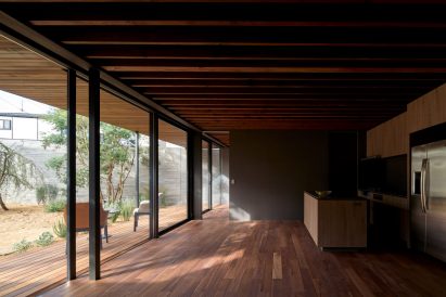 Exposed beams line the ceiling by Apollo Architects & Associates
