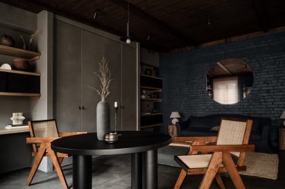 Open-plan living space with dining table, built-in storage and lounge in Kyiv apartment