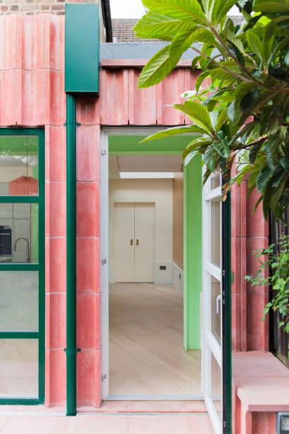 An entrance to a pink-coloured concrete house extension