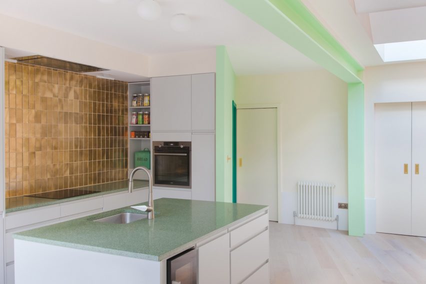 White kitchen with gold tile splashback