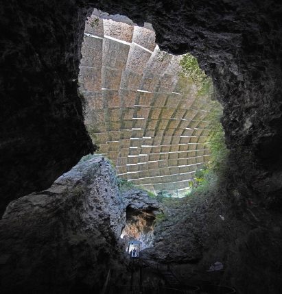 A cave covered by textured rock-like panels