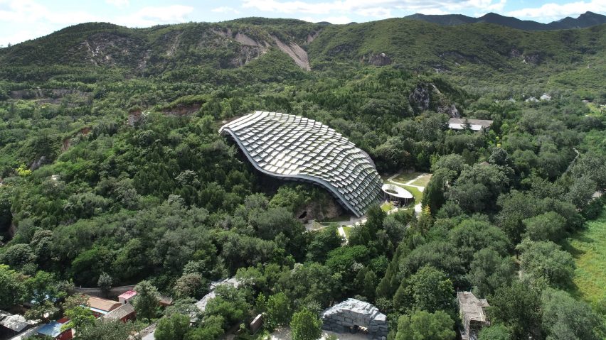 An undulating shelter made from overlapping panels