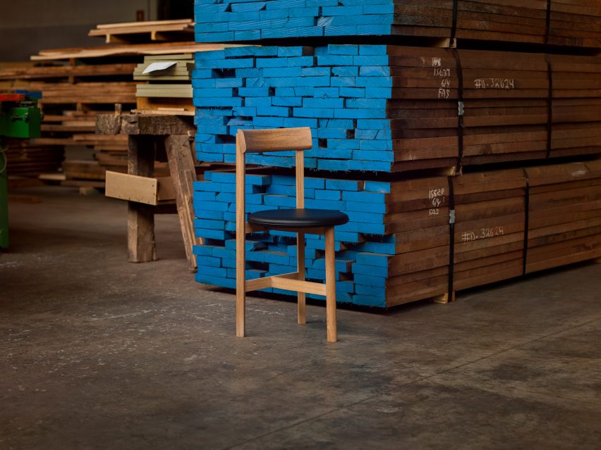 It has a leather seat and a wooden frame by Neri&Hu