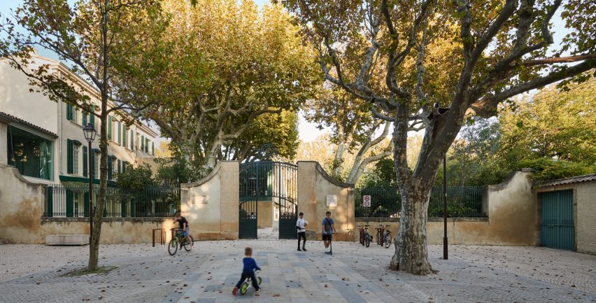 The new building reflects the walls of the grounds