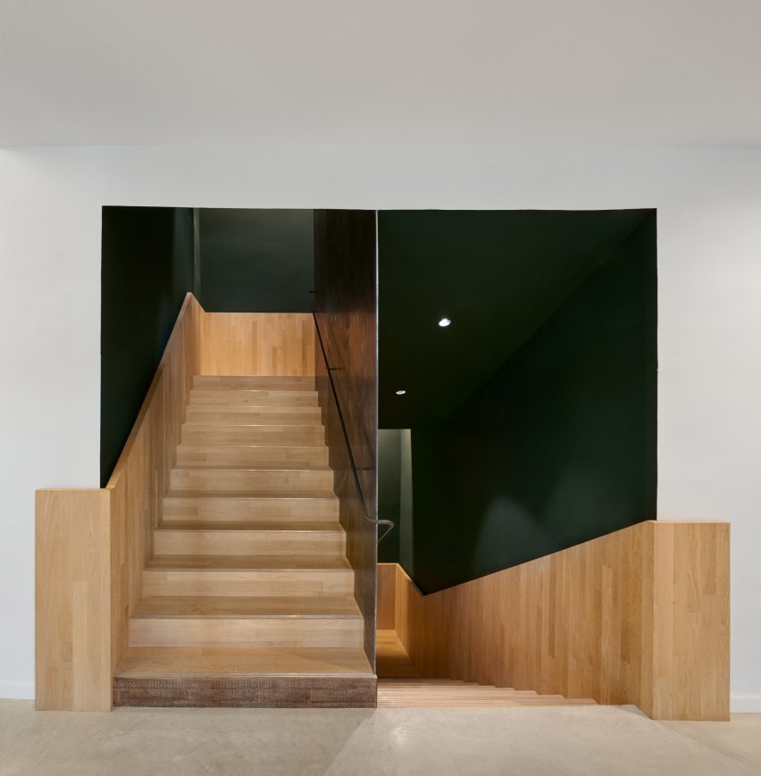 Wooden staircase fills the centre of the space