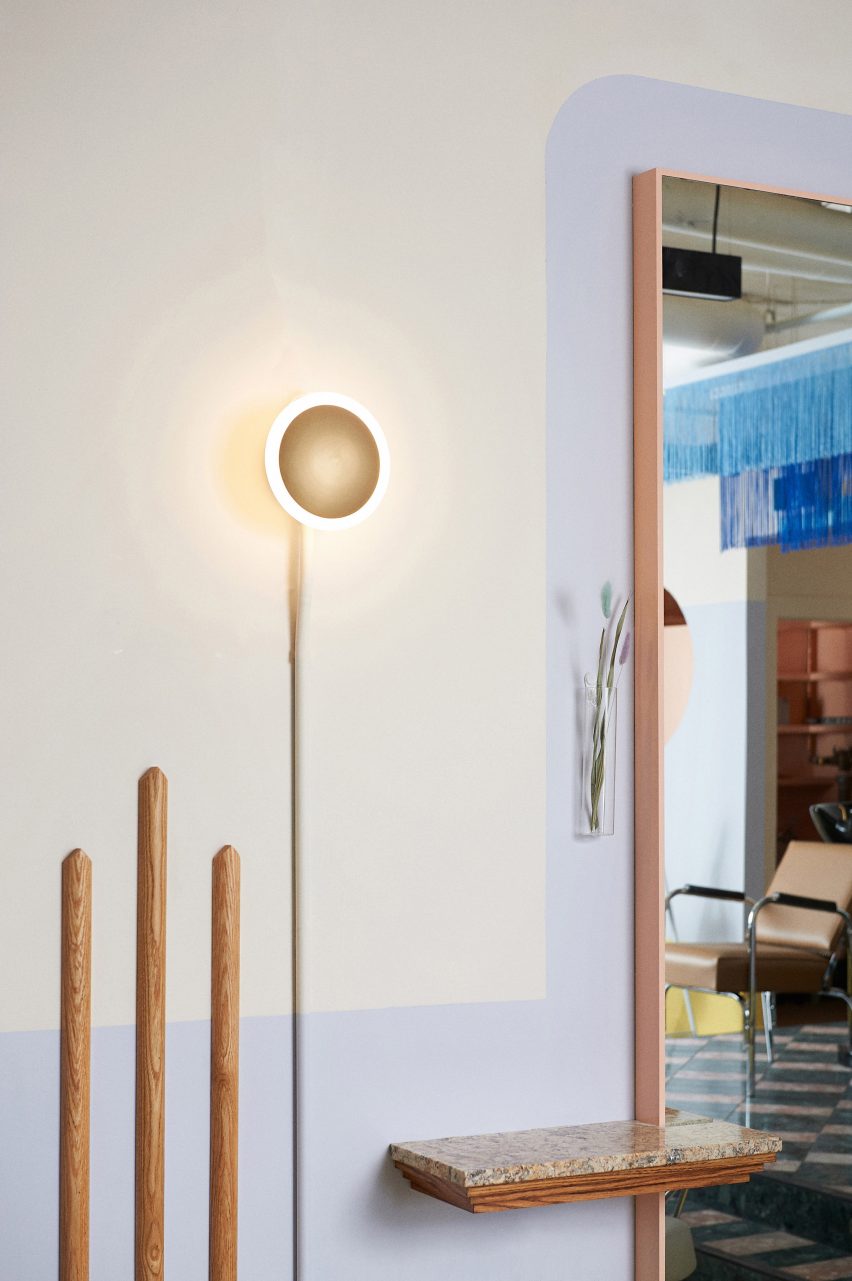 A light fixture against a pastel wall