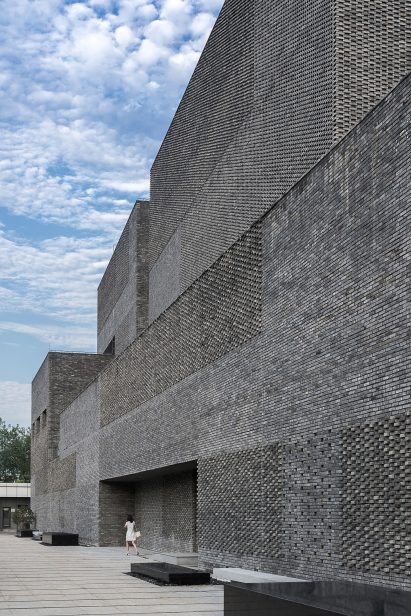 A tactile facade made from recycled grey bricks