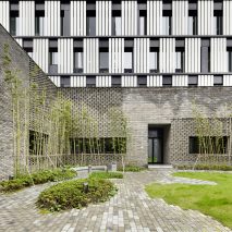 A monochrome office block with a grey brick base