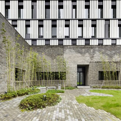 A monochrome office block with a grey brick base