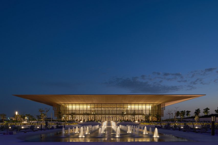 The exterior of a library with an overhanging roof by Foster + Partners