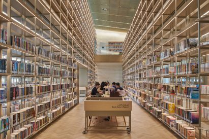 A book-filled reading space in a library by Foster + Partners