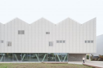 An entrance is recessed under the corner of the design by Wulf Architekten