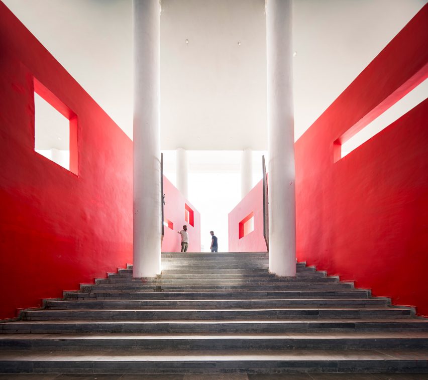 An external staircase lined with bright red walls