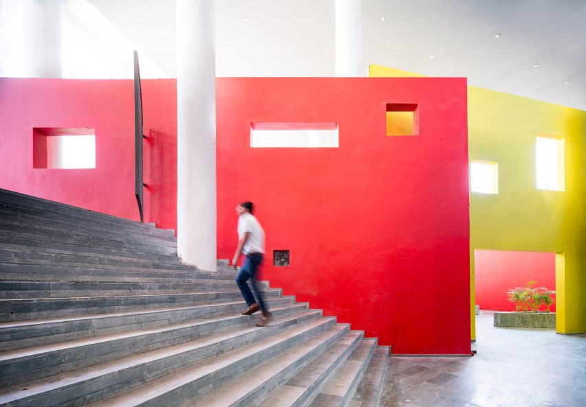 An external staircase in India lined with bright red walls