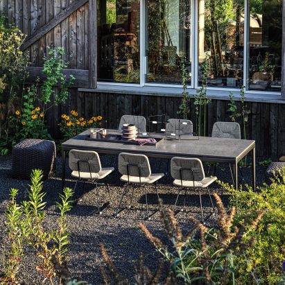 Outdoor dining space among plants in Italy