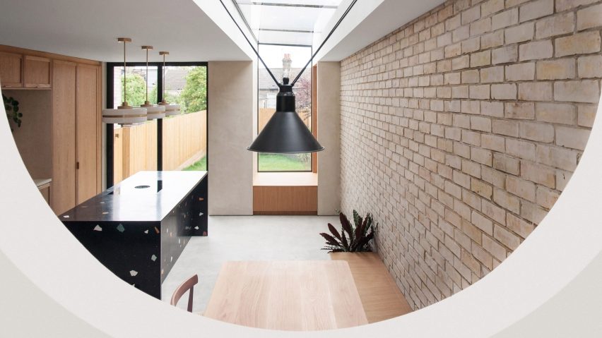 Kitchen with brick wall and terrazzo kitchen island