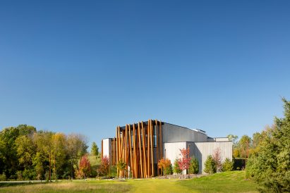 The new museum sits on a grassy and tree-dotted hillside