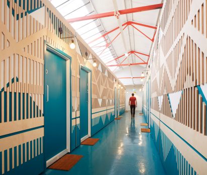 A colourful and patterned corridor made from plywood