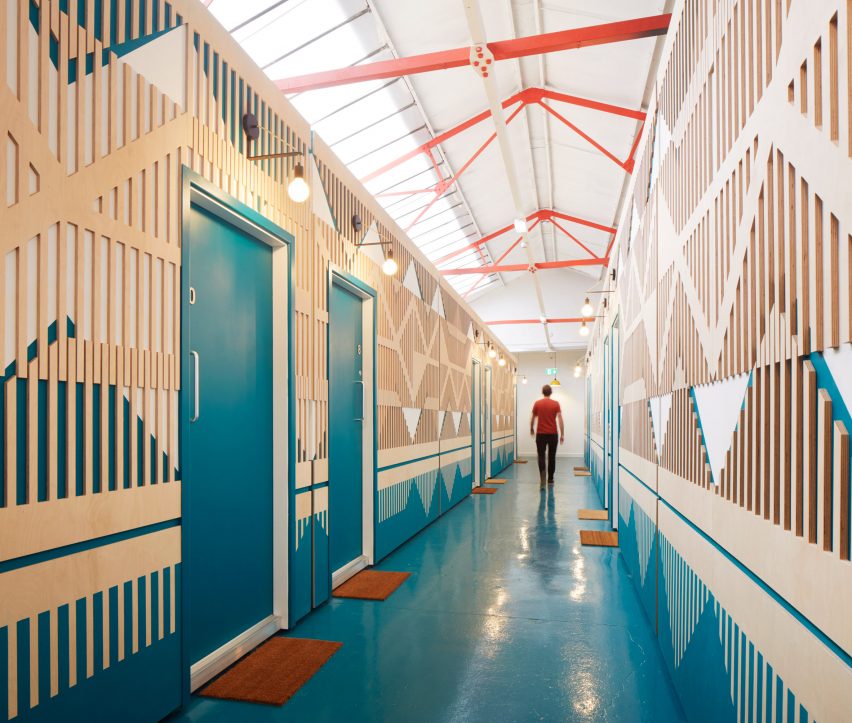 Corridor with blue and red accents on timber