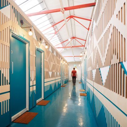 A colourful and patterned corridor made from plywood