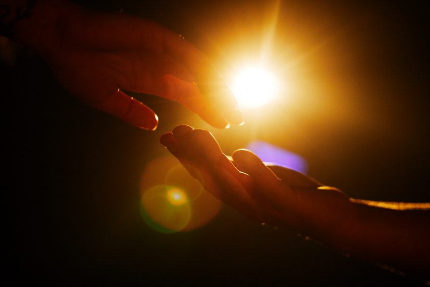 Hand touching under Urban Sun