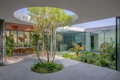 A sheltered courtyard with a tree inside a Dutch house