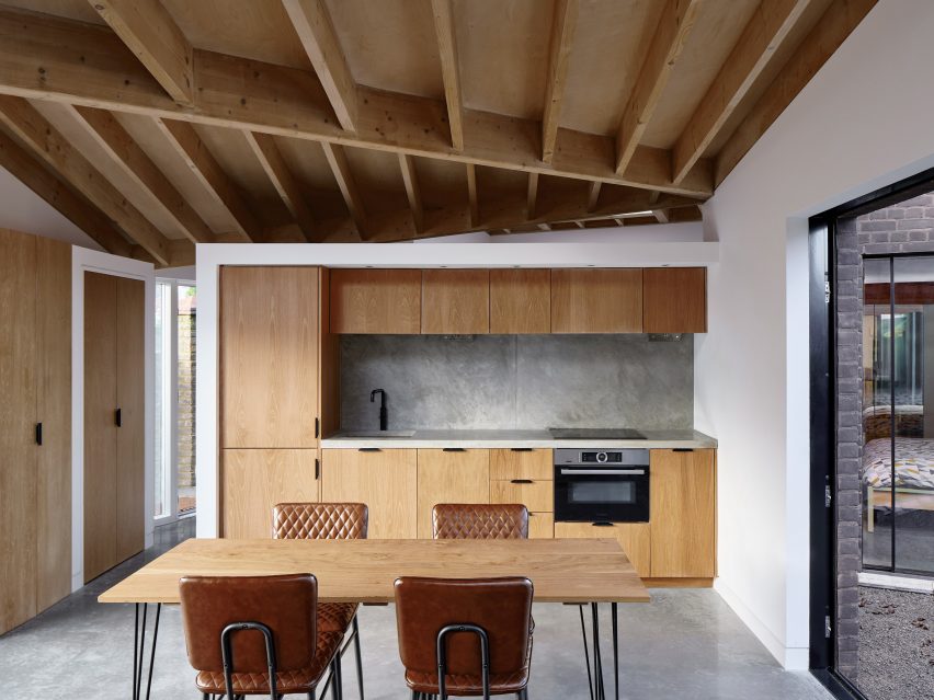 A wooden kitchen with an exposed roof