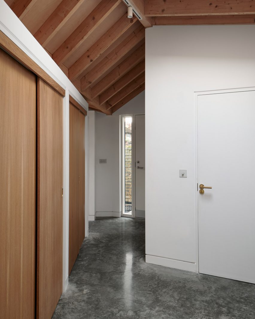 A hallway with an exposed timber roof