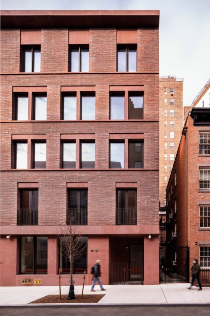 Red brick and coloured concrete facade of an apartment building