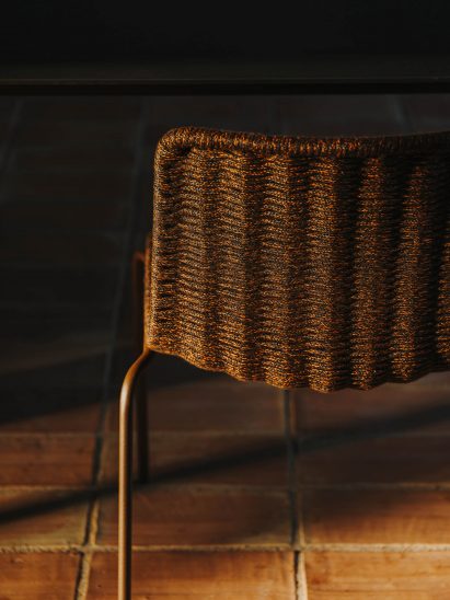 The seat and backrest are handwoven with a tightly braided weather-resistant nautical rope