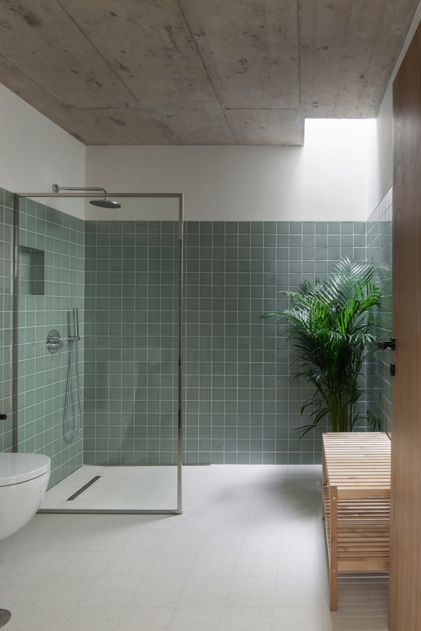 Its bathroom employs a sage tiled design