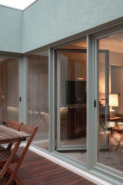 Exterior walls have a green finish by depA Architects
