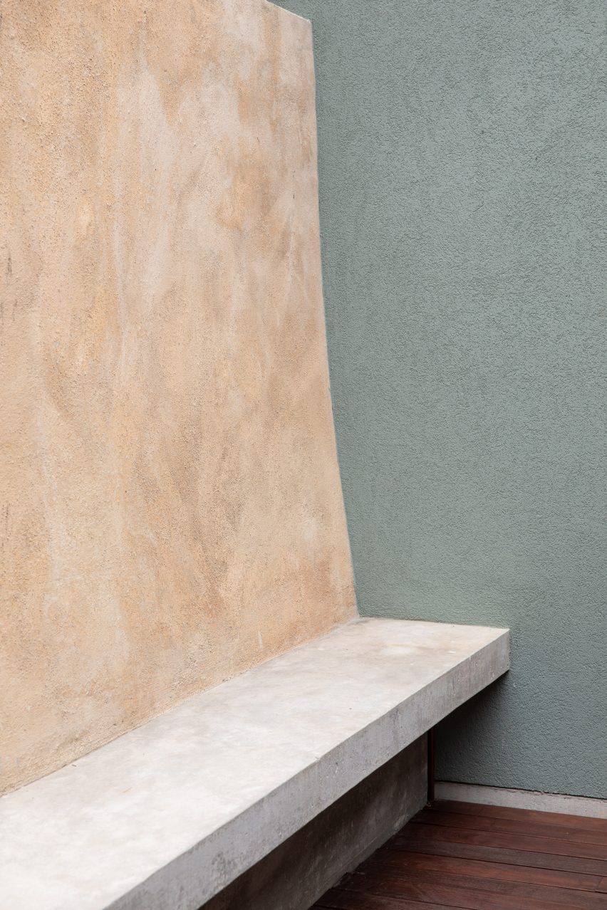 Ochre hued concrete is combined with sage green