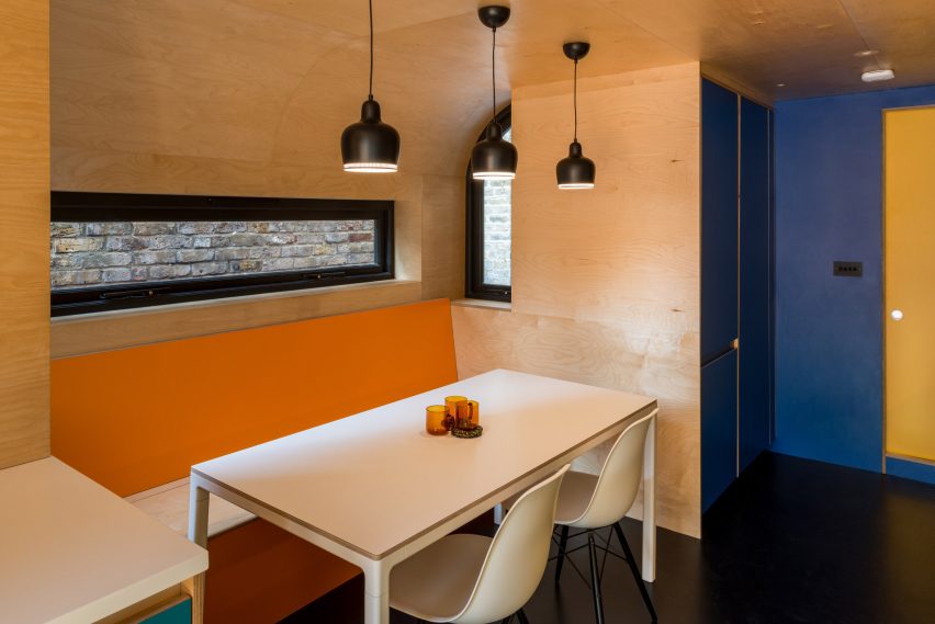 A wooden kitchen with pops of colour