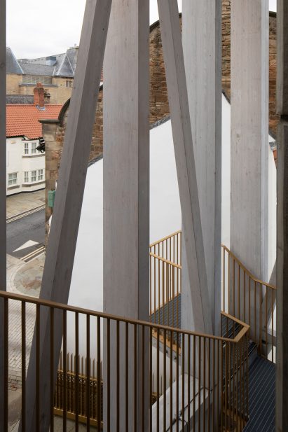 A staircase with a golden balustrade