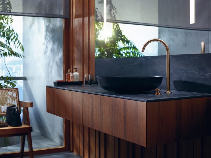 A wooden sink unit with a gold tap