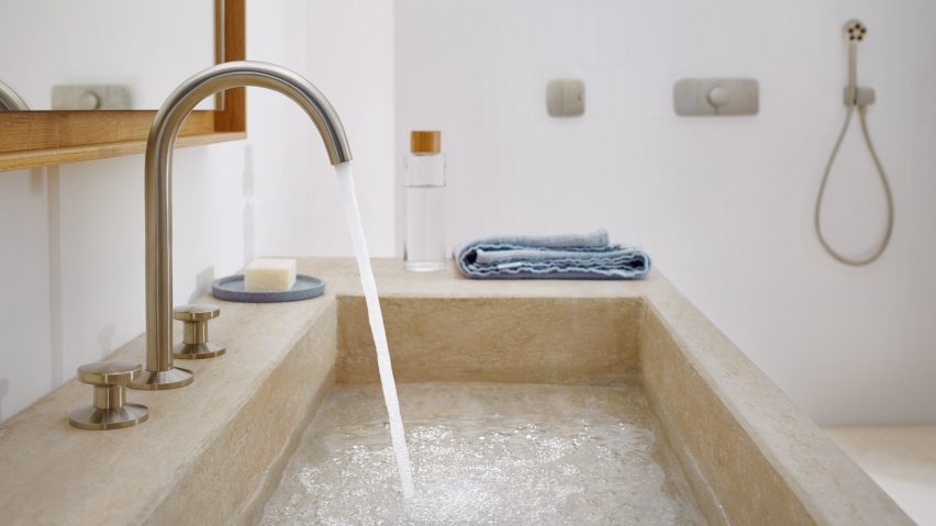 A stone sink with a large chrome tap