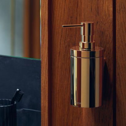 A brass soap dispenser by Axor