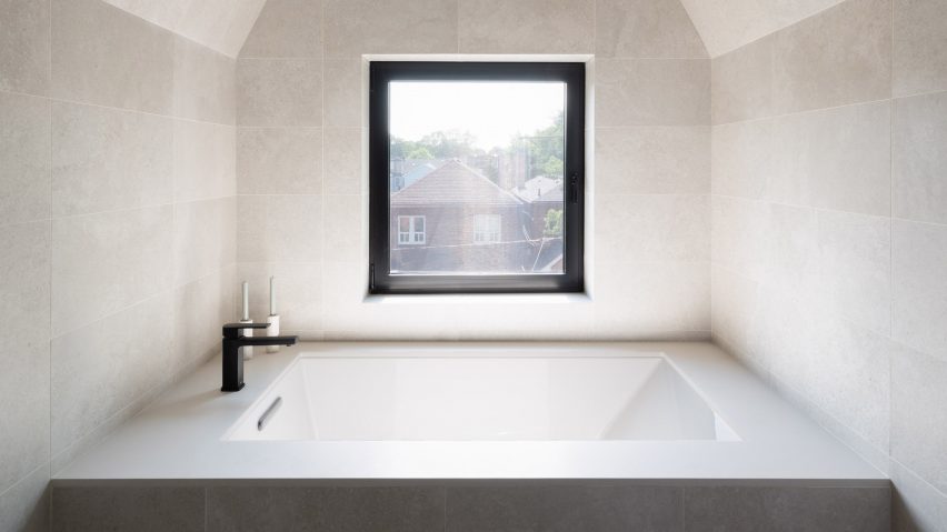 Grey tiles cover the walls of this bathroom