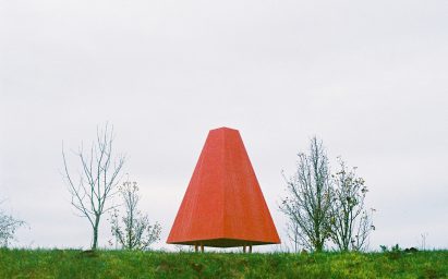 A bright red pavilion with a large hip roof