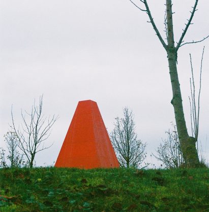 A bright red pavilion in a park